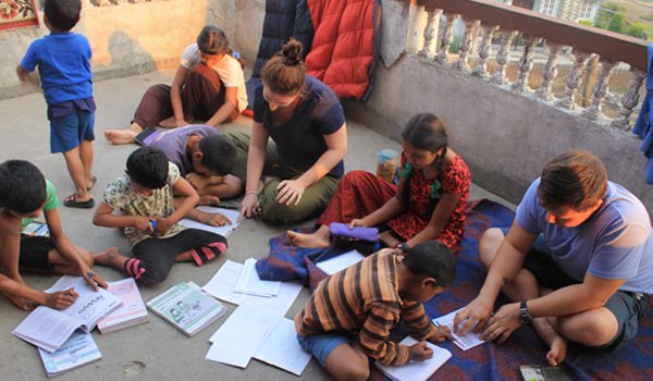 volunteer teaching orphan kids in nepal